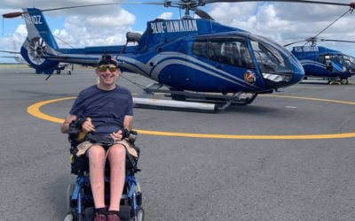 Photo of Lindsay alongside helicopter